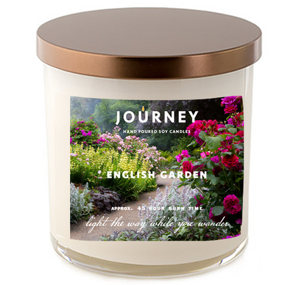 Journey Candle's English Garden soy wax candle in a glass tumbler style jar. The label features an English garden with roses, lavender and other flowers in full-bloom.